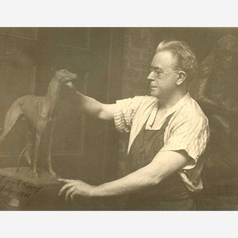 Artist working on greyhound sculpture