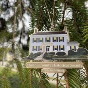 Anniversary ornament hanging on pine branch