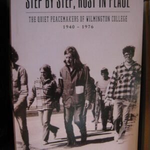 Black-and-white photo of Woodstock attendees walking outdoors in 1969.