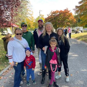 Family enjoying a sunny autumn day outdoors together.