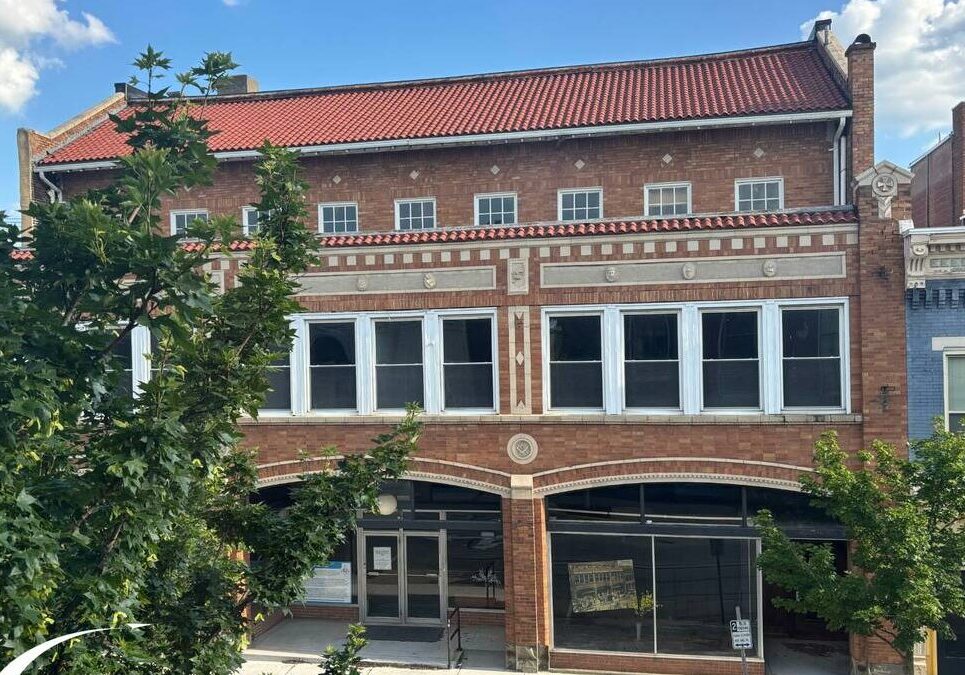 Historic brick building with red roof
